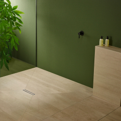 beige großformat duschbodenfliesen in pentagonform mit linearablauf vor grüner wand