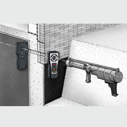 laserempfänger mit digitalanzeige und sender an mauerdurchbruch neben injektionspistole