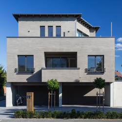 minimalistisches zweistöckiges haus mit hellgrauer betonfassade balkon großformatfenstern carport hausnummer 12
